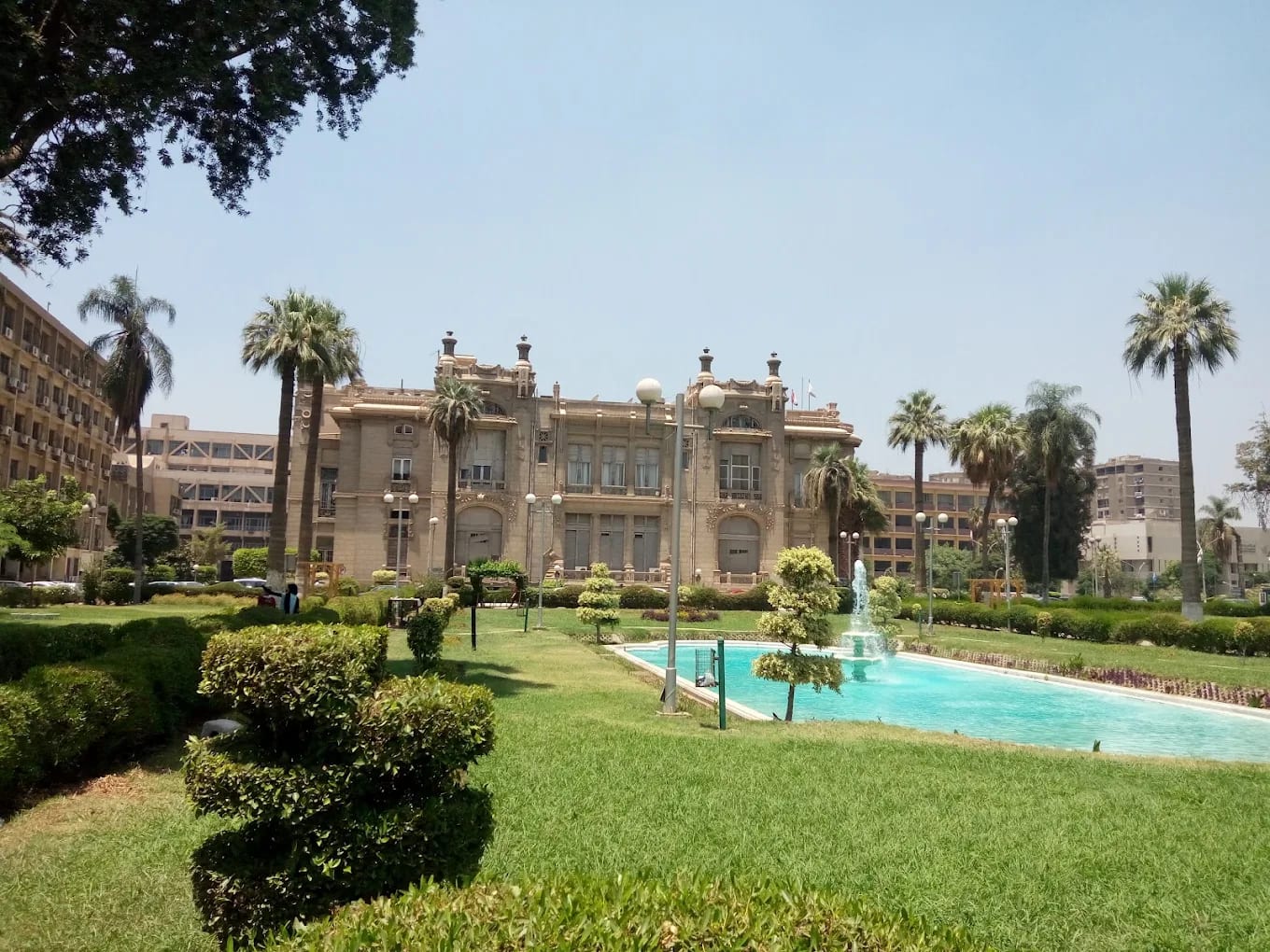 The historic landmark palace building of Ain Shams University in Cairo, with its gardens and fountain