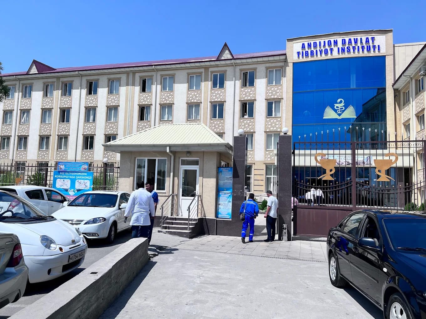 The main building of Andijan State Medical Institute with its blue-glass entrance and signage