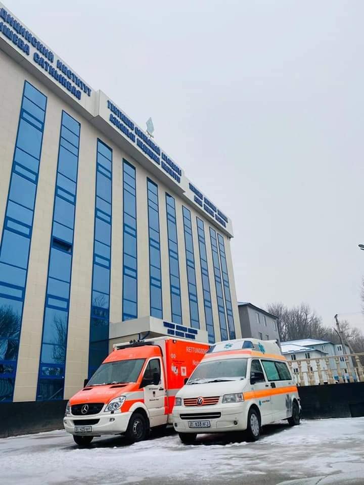 An Asian Medical Institute building with an ambulance parked outside