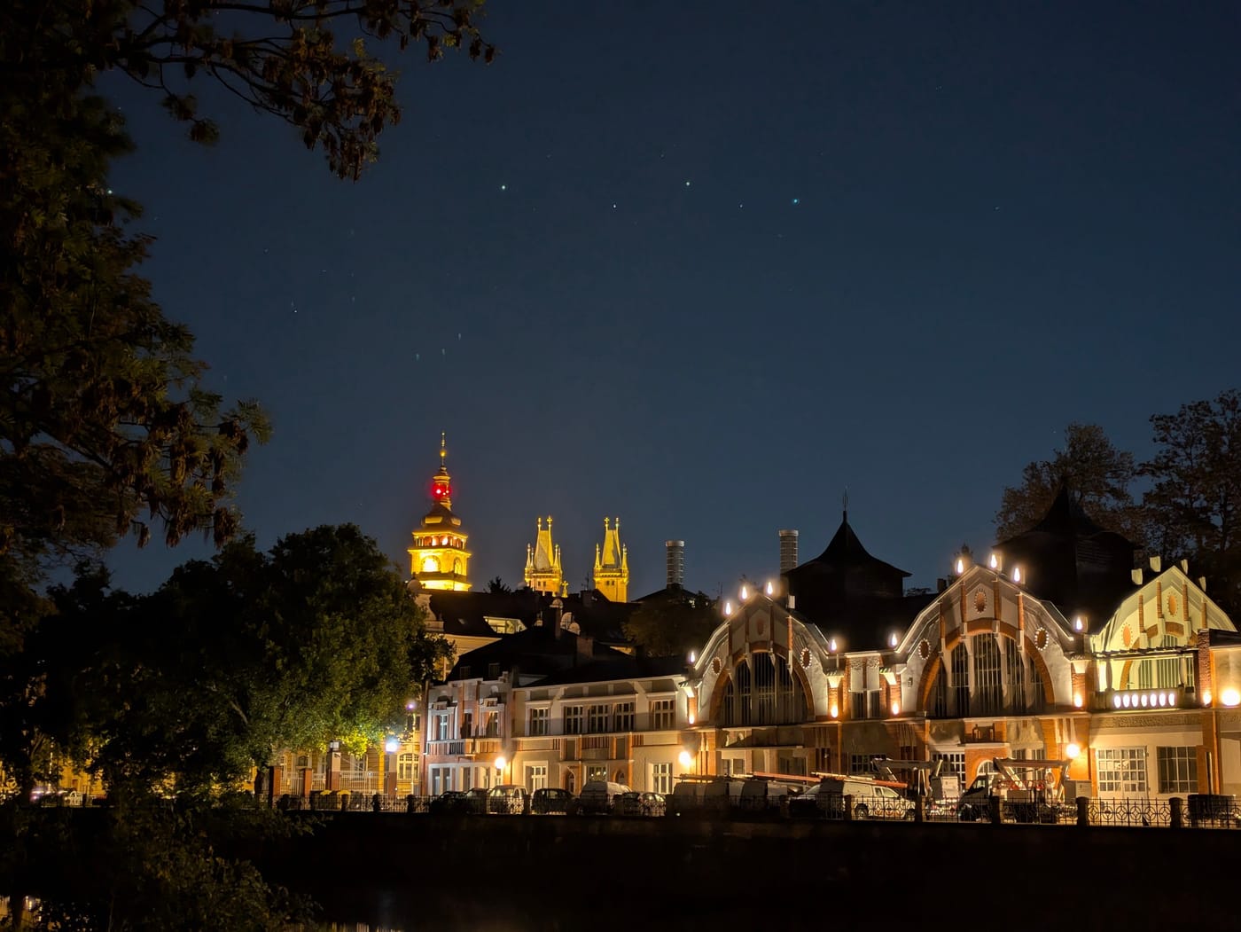 Historic towers of Hradec Králové reflected in the river at night