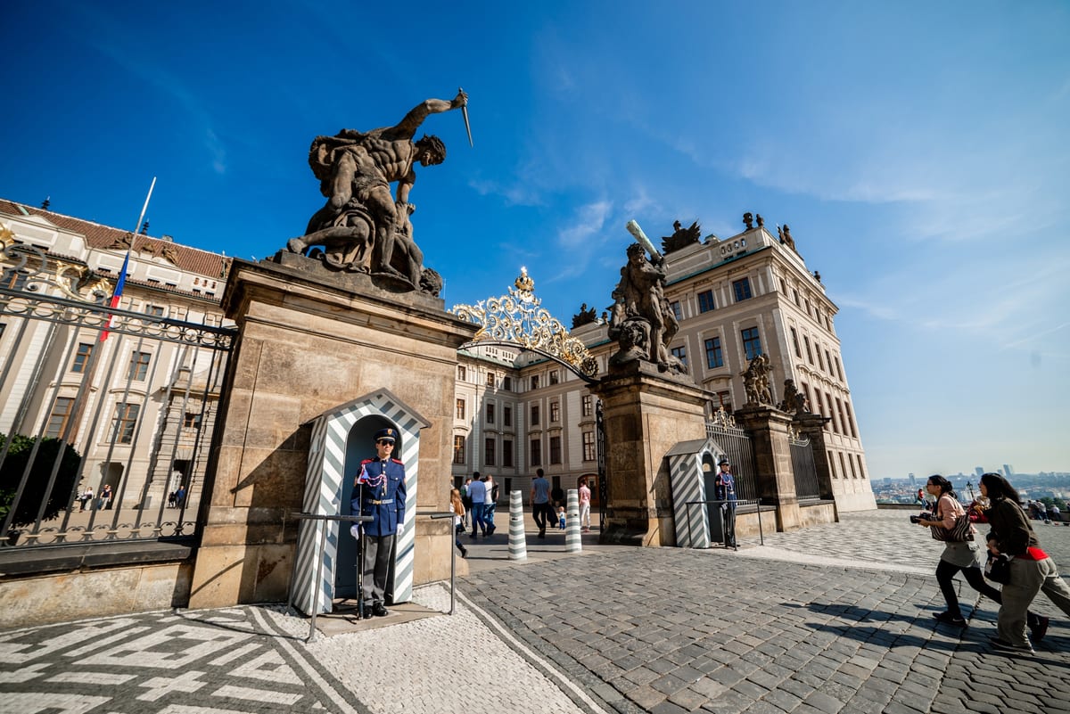 Visitors at the Prague Castle gates on a sunny day