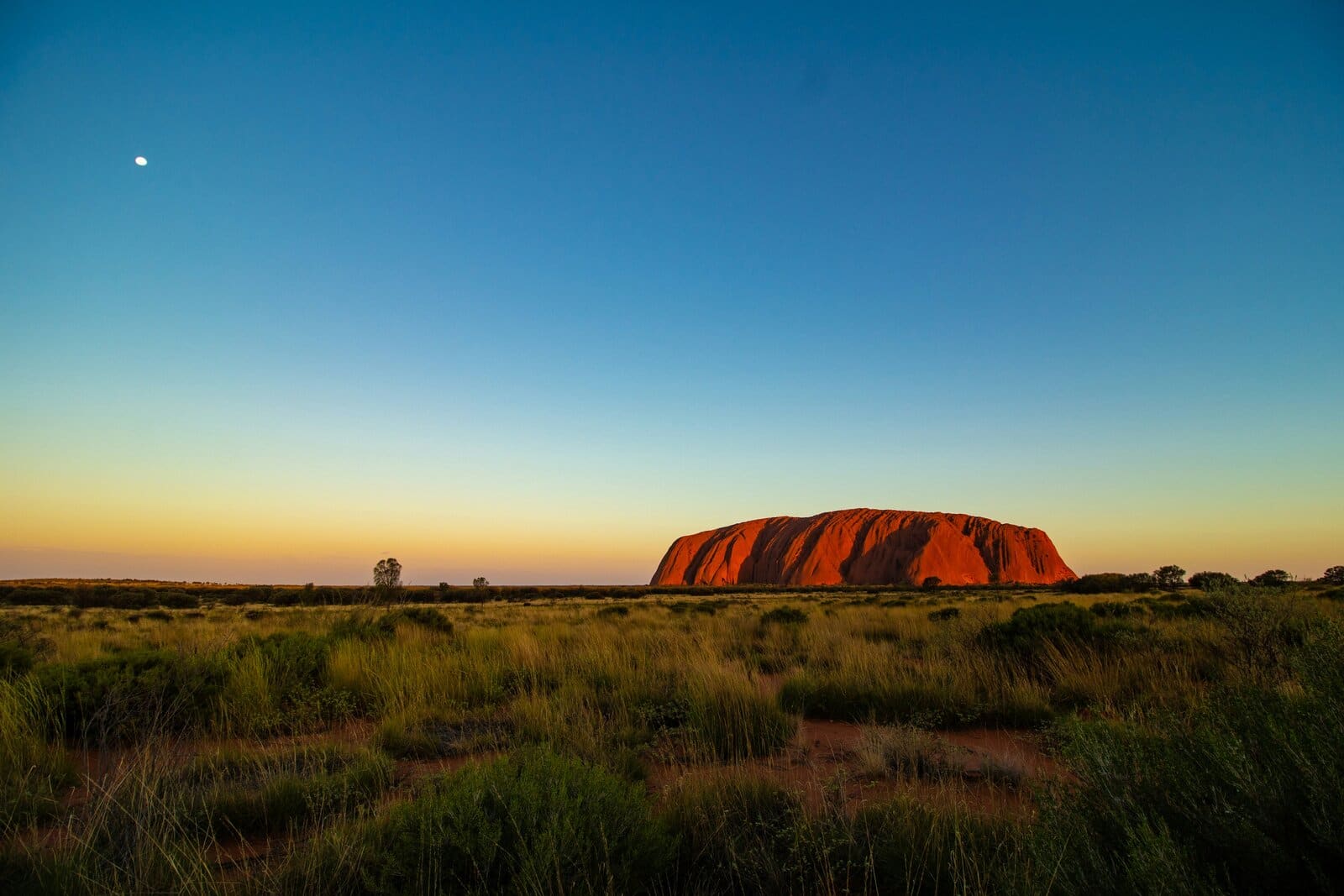 Uluru (Ayers Rock) glowing red at dusk in the Northern Territory, Australia