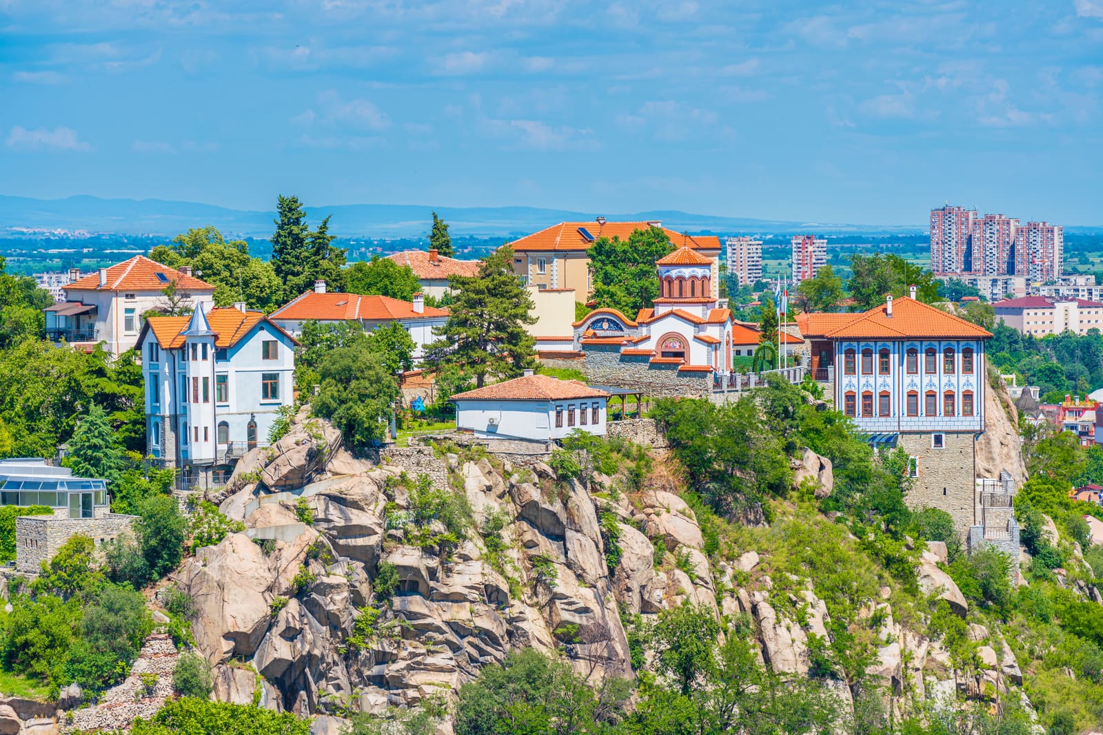 Old Town houses on the rocky hills of Plovdiv with the modern city behind