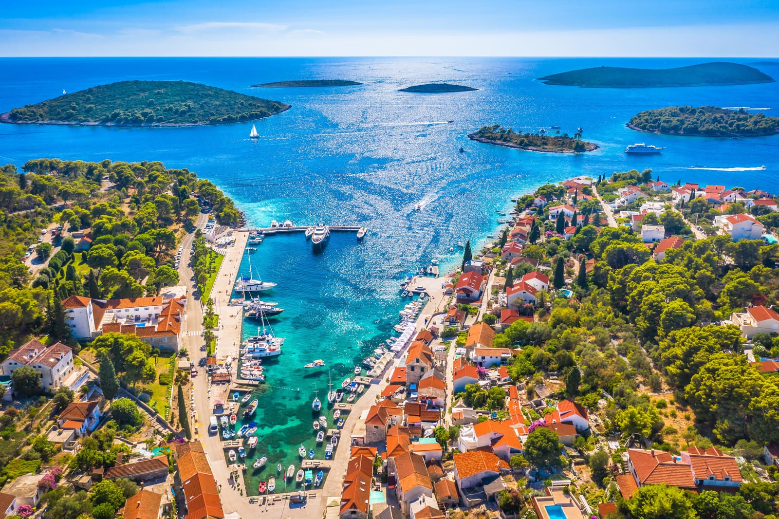 Aerial view of an Adriatic island harbour with moored boats