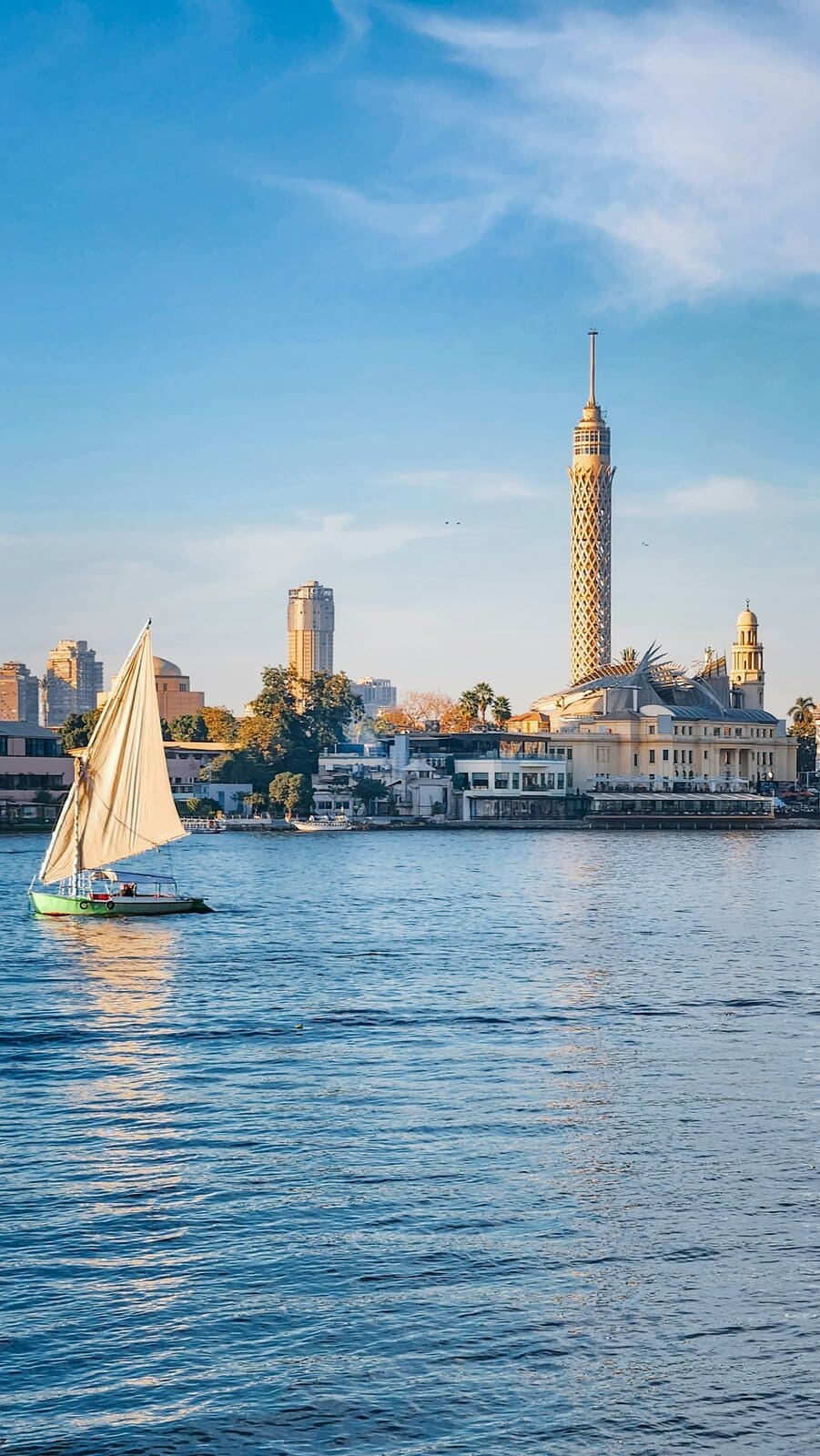 The Cairo Tower and a felucca sailing boat on the River Nile, Cairo, Egypt