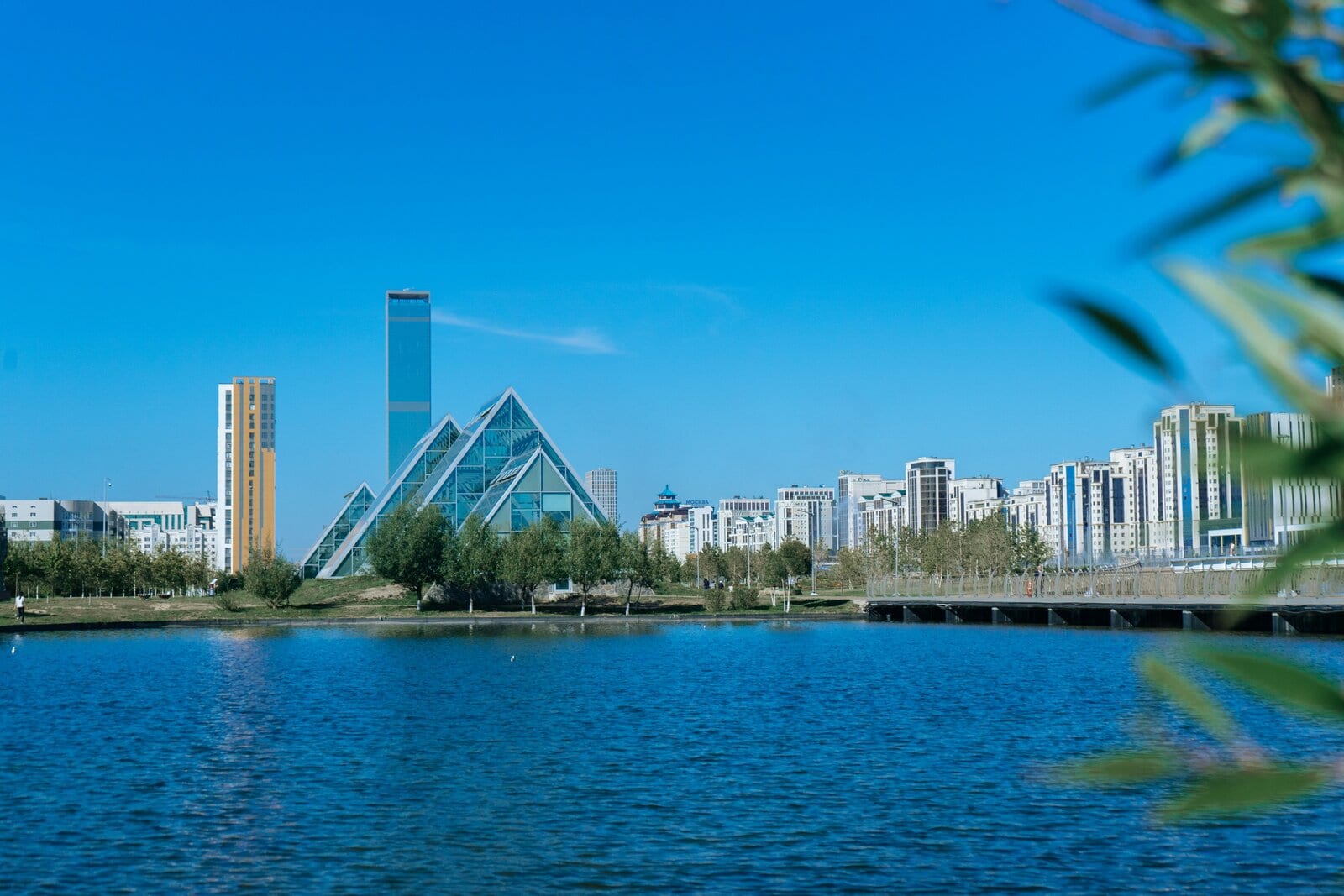 Modern Astana skyline with a glass pyramid building beside the river, Kazakhstan
