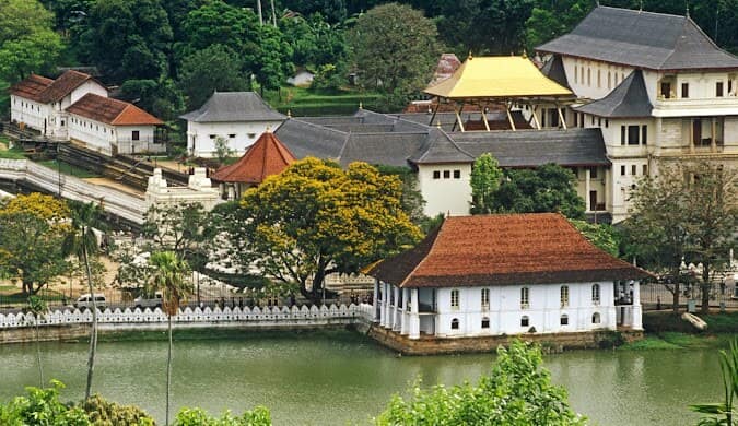 Temple of the Sacred Tooth Relic beside the lake in Kandy, Sri Lanka