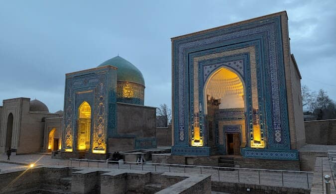 Illuminated Shah-i-Zinda necropolis at dusk in Samarkand, Uzbekistan
