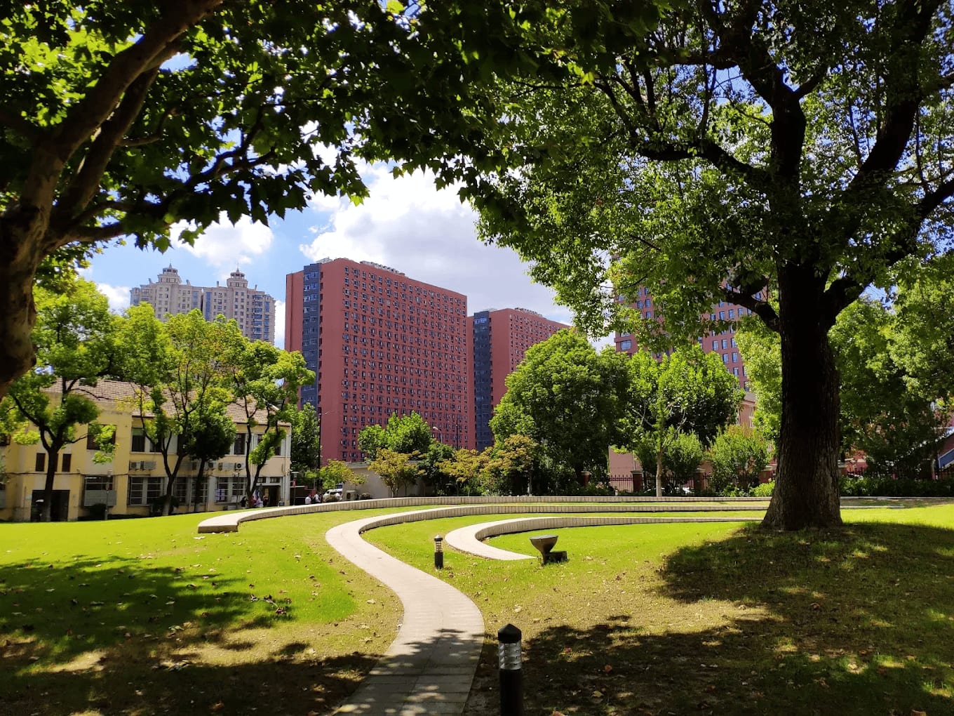 A green campus space with student residence towers at Fudan University in Shanghai