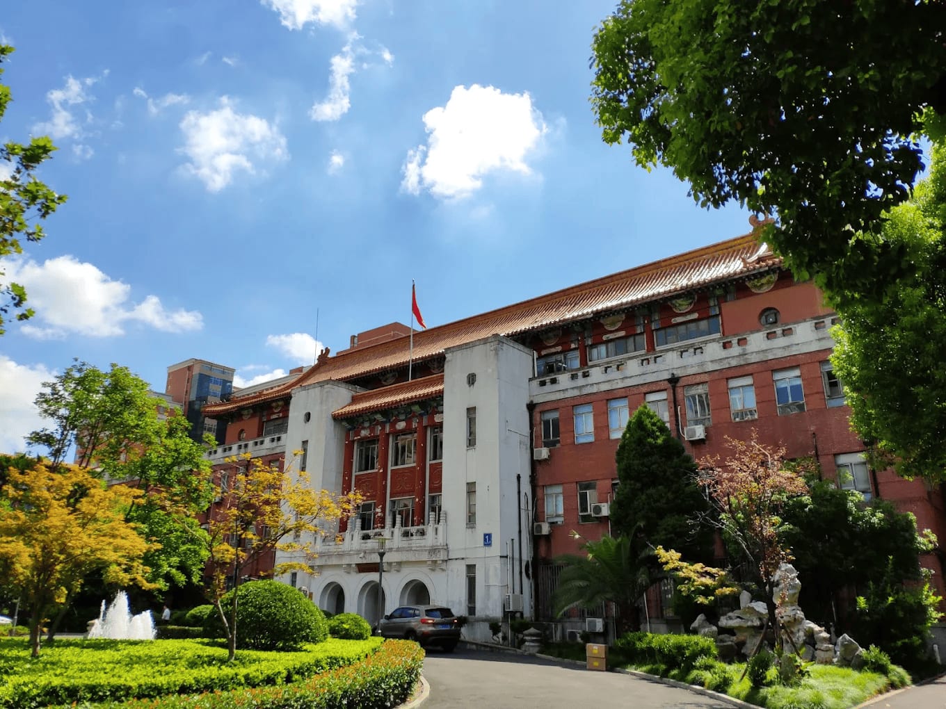 The historic red-brick main building of Fudan University Shanghai Medical College with its Chinese roof and fountain