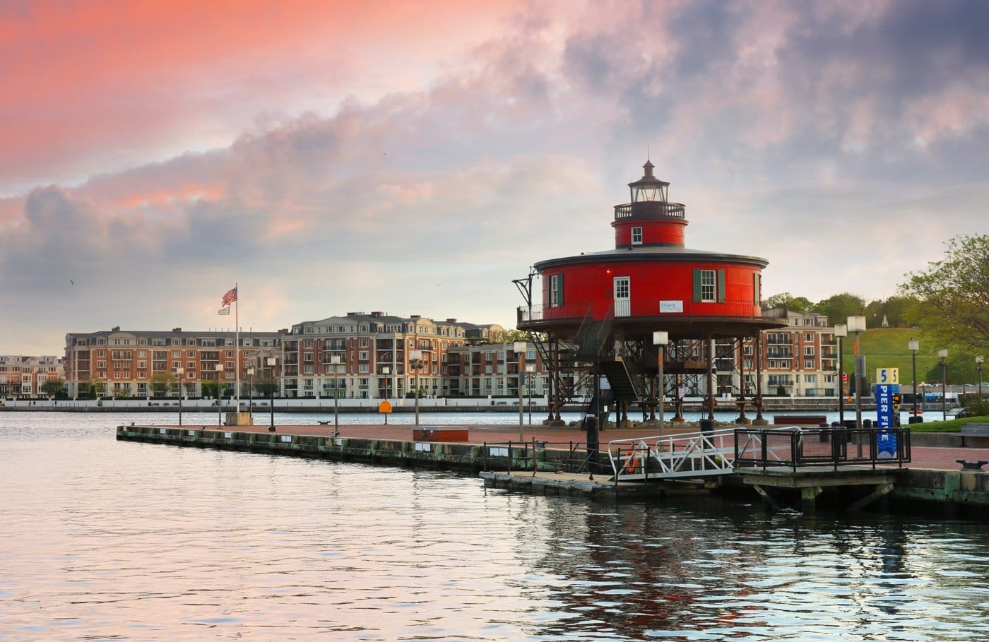 A historic lighthouse and waterfront in the Baltimore harbor