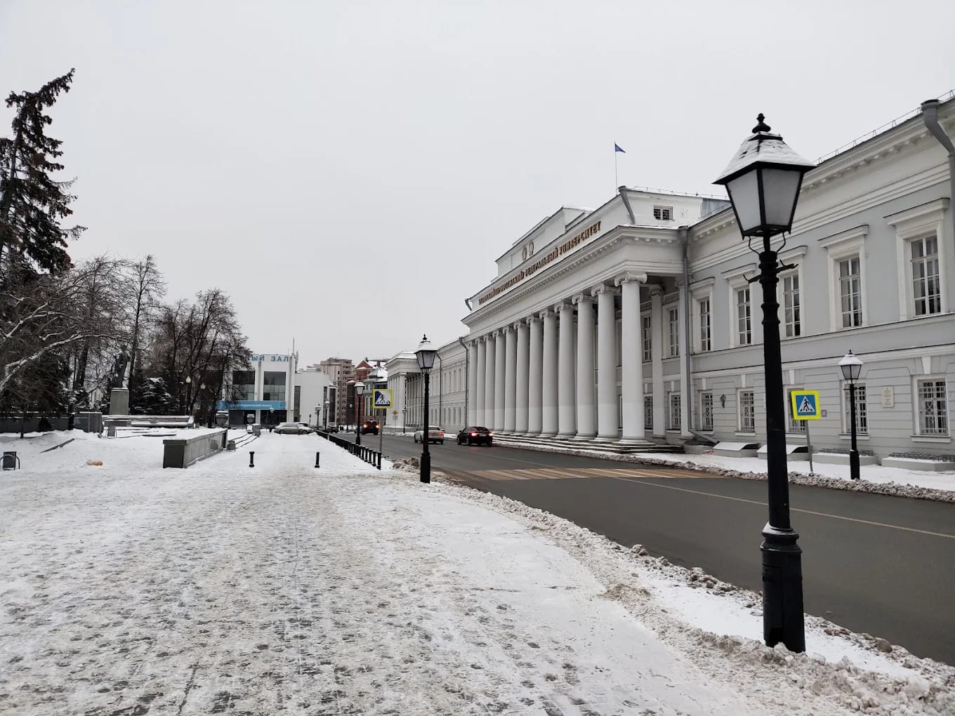 The white columned main building of Kazan Federal University in the snow, with its Russian signage