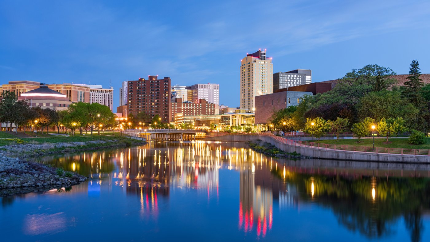 A Minnesota riverfront and city skyline at dusk