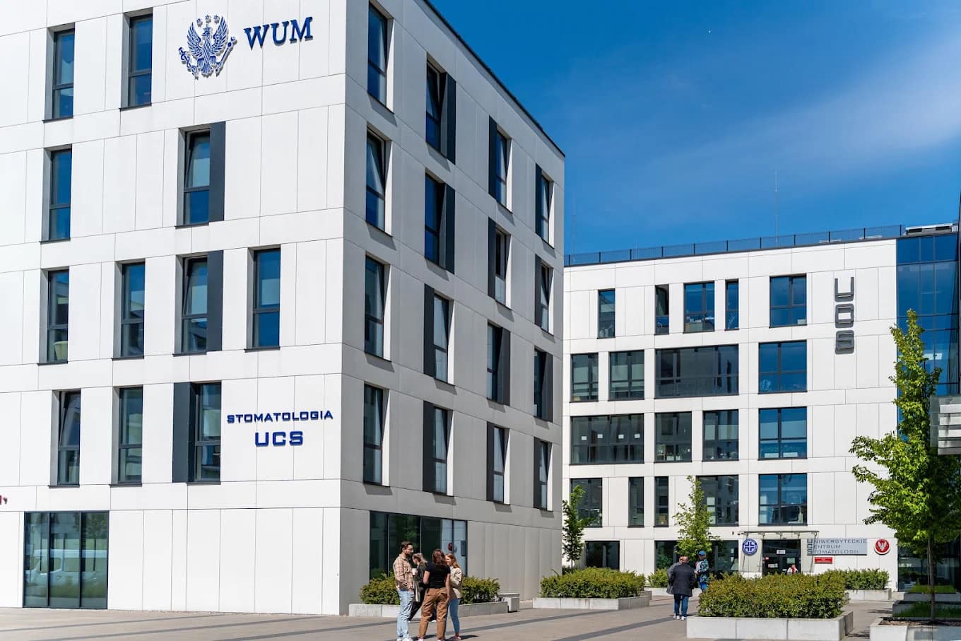 A modern WUM faculty building with the university logo