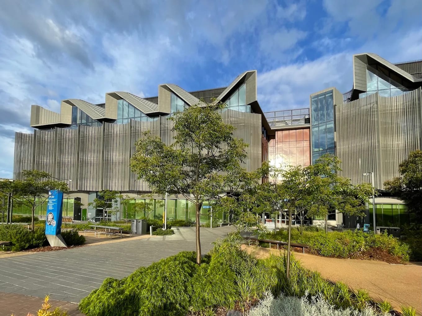 A Monash University building at the Clayton campus with a distinctive curved roofline and landscaped forecourt, Melbourne