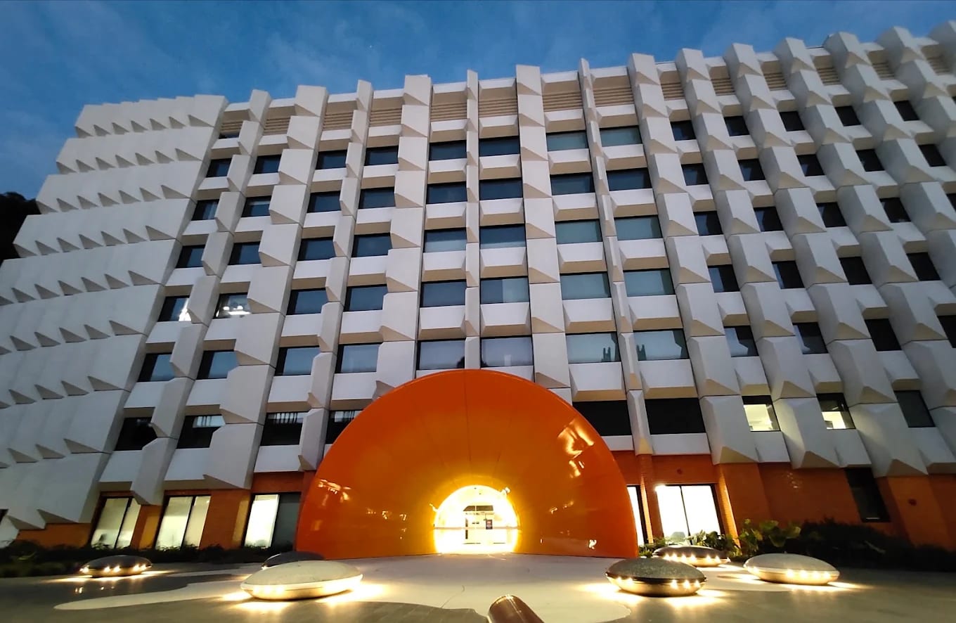The iconic orange tunnel entrance at Monash University's Clayton campus, illuminated at dusk, Melbourne