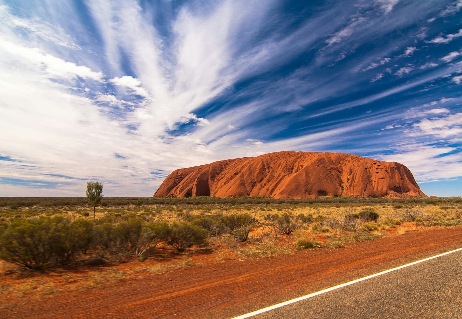 Uluru (Ayers Rock) rising from the desert in Australia's Northern Territory — national travel context, not Melbourne