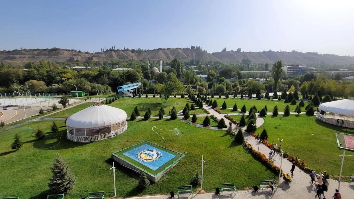 The green grounds and gardens of the Osh State University campus