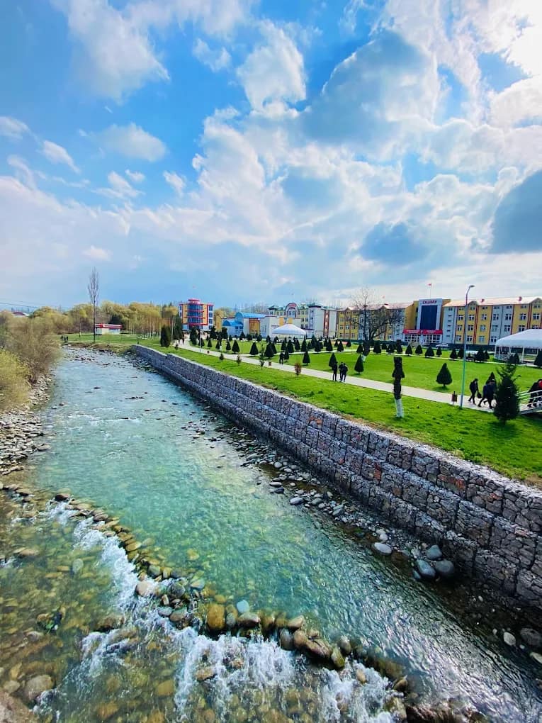The Osh State University campus with gardens and a river running through it