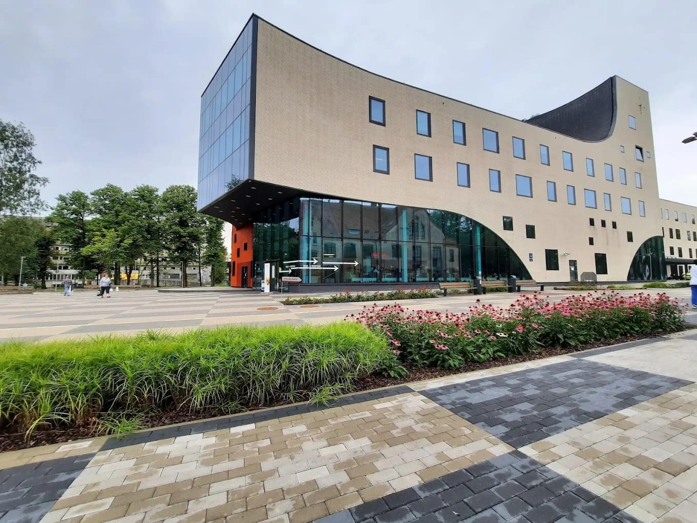 A modern curved-glass Riga Stradiņš University building