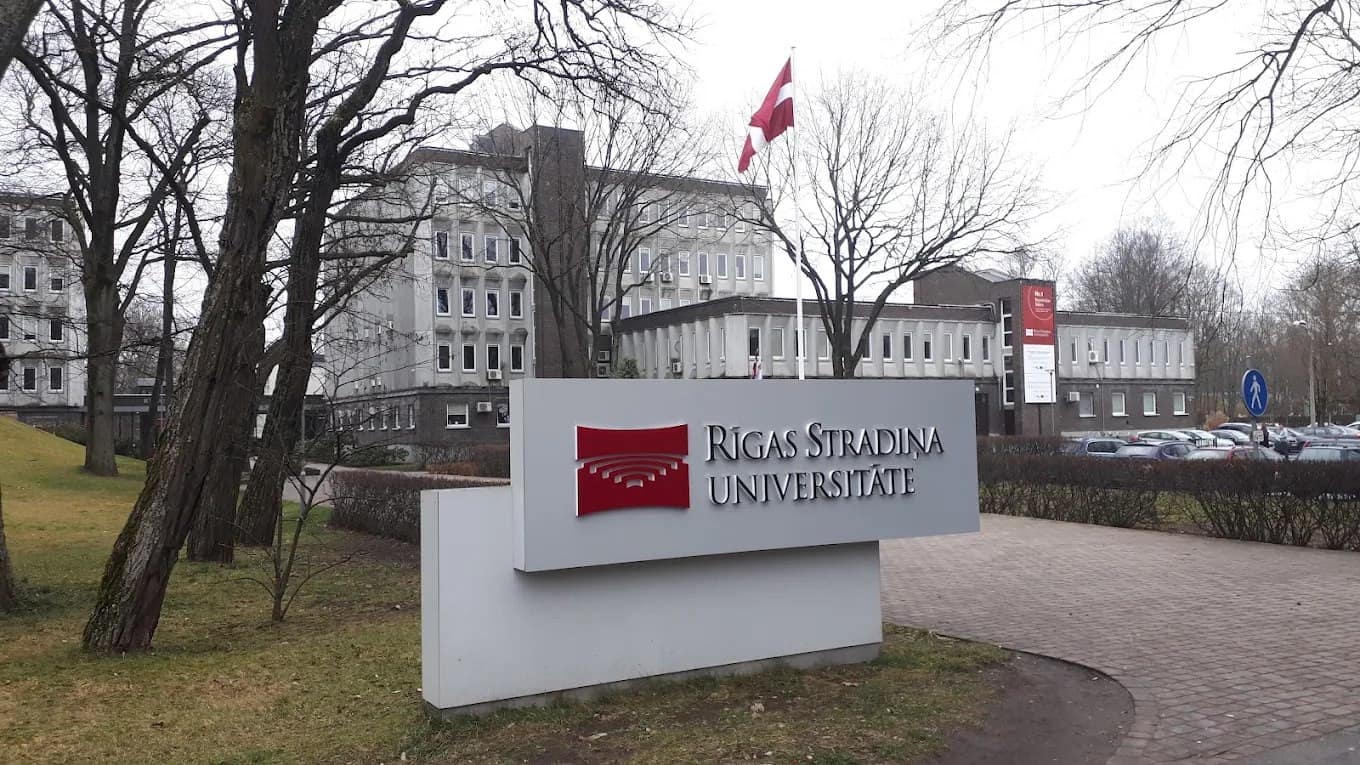 The Riga Stradiņš University sign with the Latvian flag