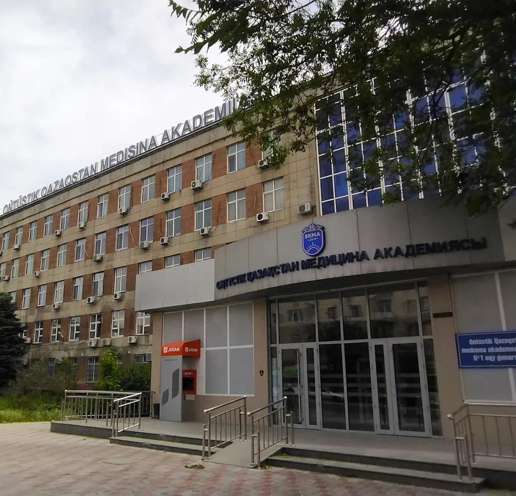 An academic building of South Kazakhstan Medical Academy in Shymkent, with the SKMA emblem and signage