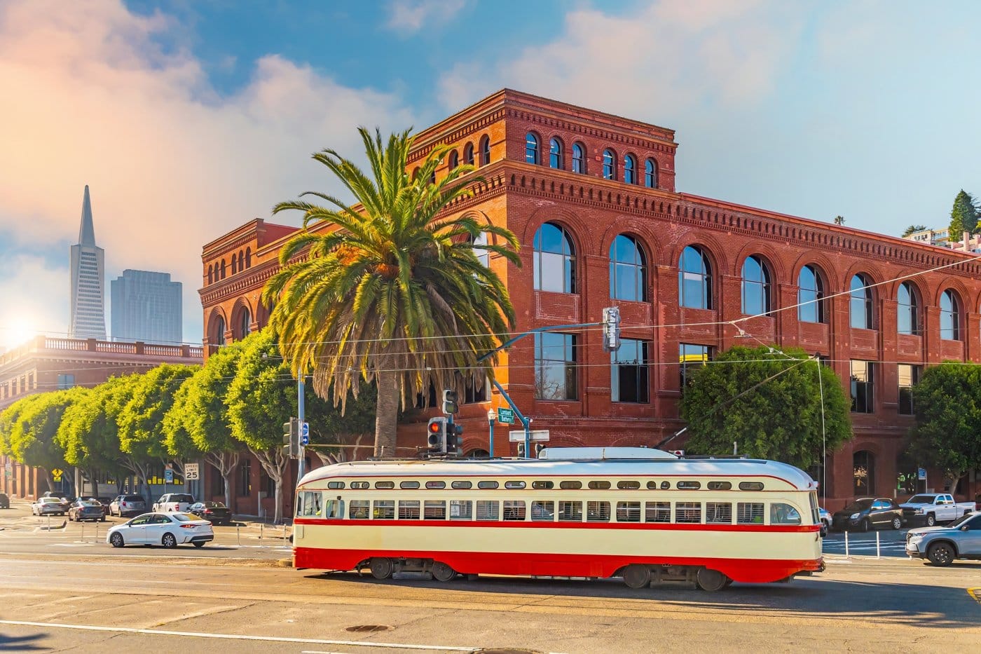 A historic streetcar on a San Francisco street near a brick building