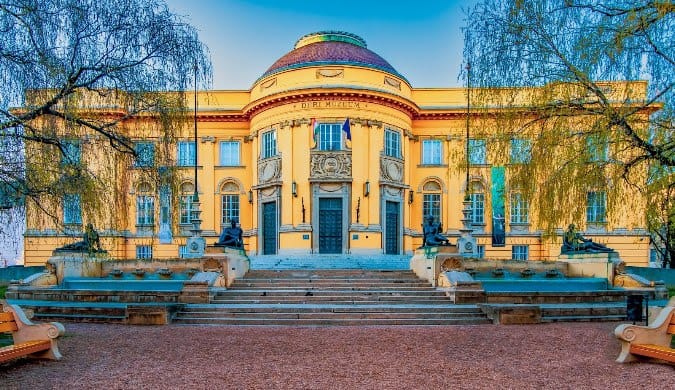 A historic domed building with fountains in Debrecen, Hungary