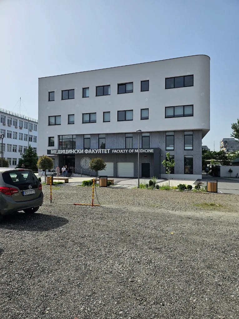 A modern building of the University of Novi Sad Faculty of Medicine with the 'Faculty of Medicine' signage