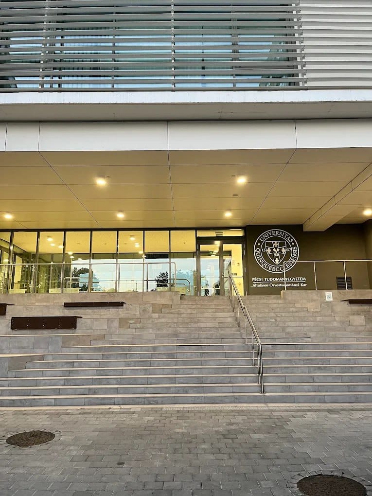 The entrance to the University of Pécs Medical School with its emblem