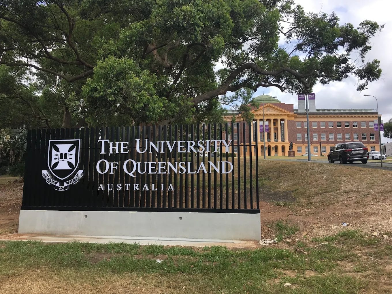 'University of Queensland Australia' entrance signage with the UQ crest in front of the historic Mayne Medical School building, Herston, Brisbane