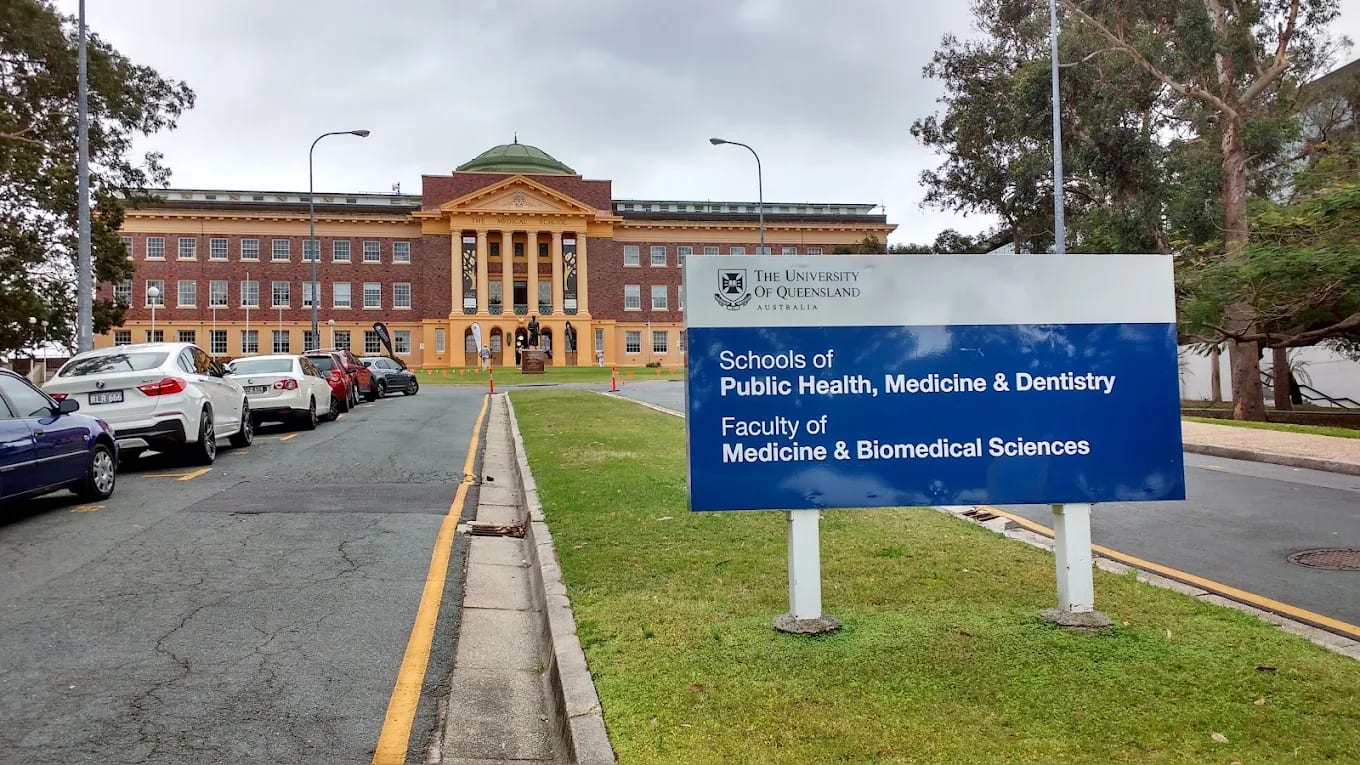 University of Queensland signage reading 'Faculty of Medicine & Biomedical Sciences' in front of the historic Mayne Medical School building, Herston, Brisbane