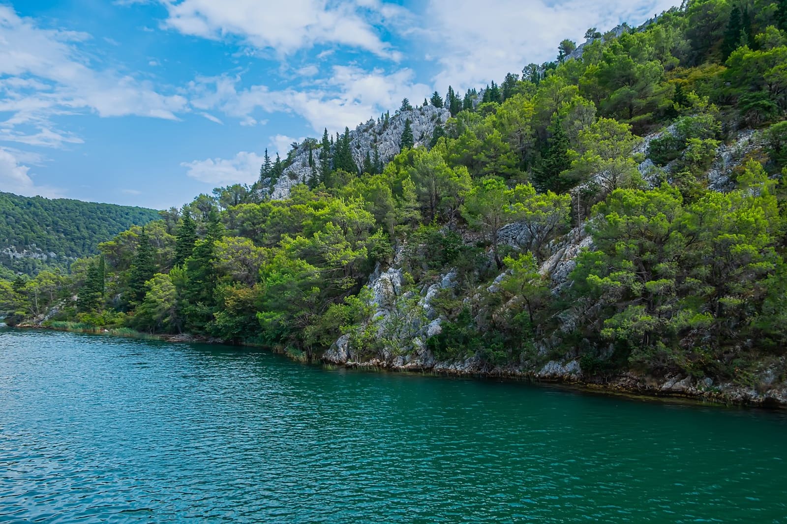 A karst river canyon with clear turquoise water in the Dalmatian hinterland near Split, Croatia
