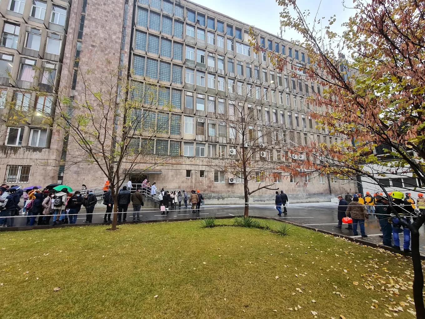 Students outside a YSMU campus building on an autumn day