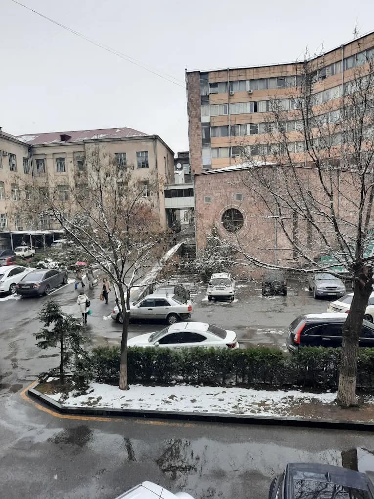 A YSMU campus building on a Yerevan street in winter