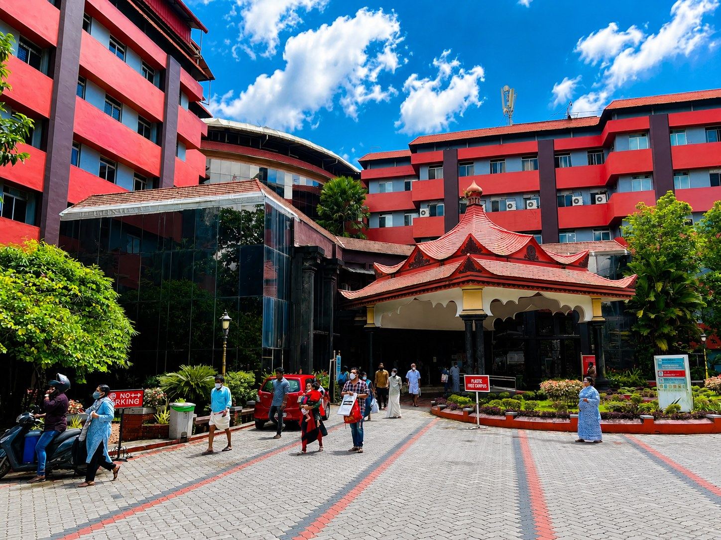 The red campus buildings and plaza at Amrita Institute of Medical Sciences, Kochi