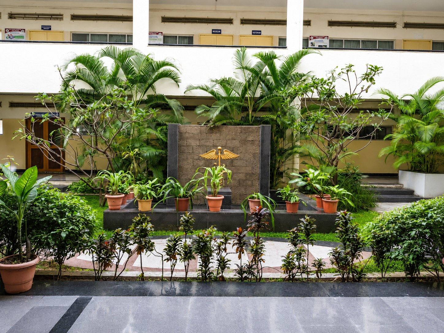 The central courtyard garden with the medical caduceus at Bharati Vidyapeeth Medical College, Pune