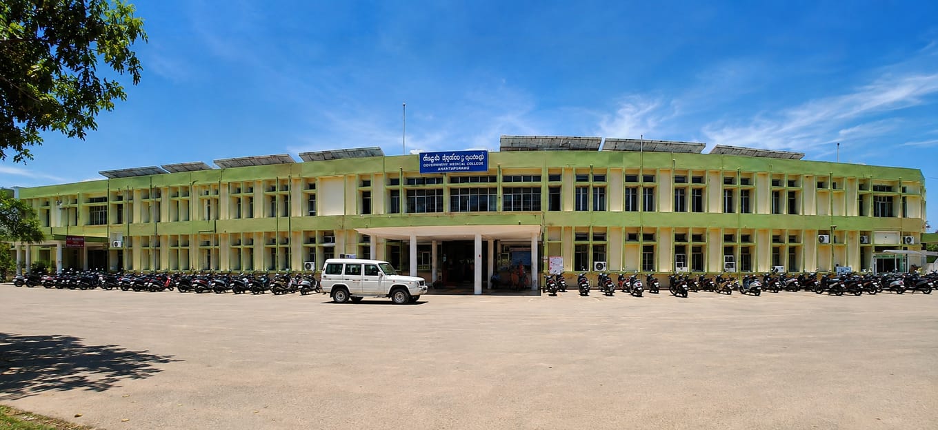 The main building of Government Medical College, Ananthapuram, its blue Telugu-and-English signboard over the entrance canopy