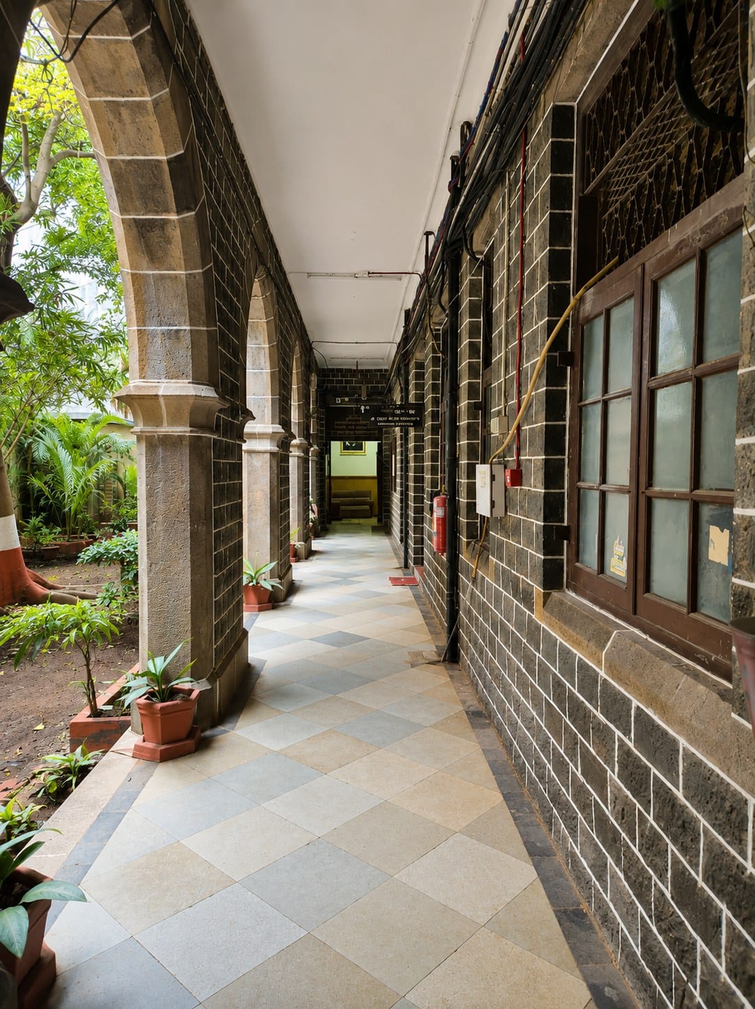A heritage stone-pillared corridor at GMC L.T. Marg, Mumbai