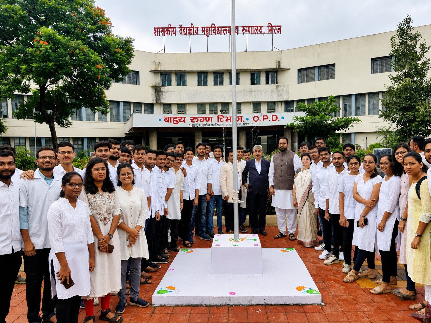 Students and faculty at a flag-hoisting event outside the GMC Miraj OPD building