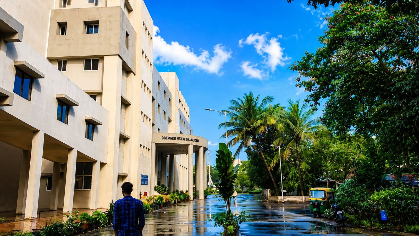 A GMC Surat building with palm-lined campus