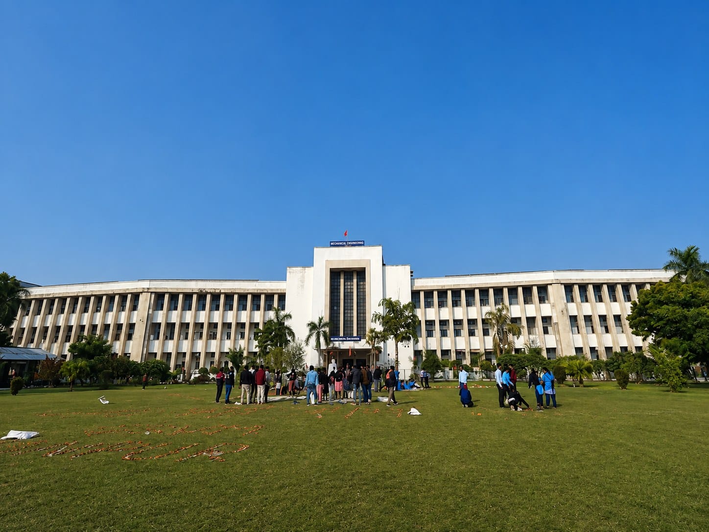 A GSVM Medical College building with students on the lawn, Kanpur