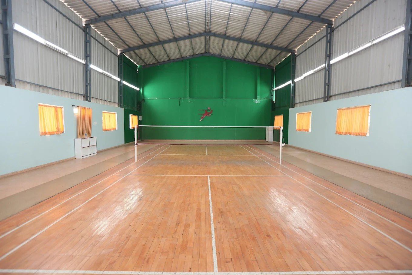 The indoor badminton court at KIMS Karad