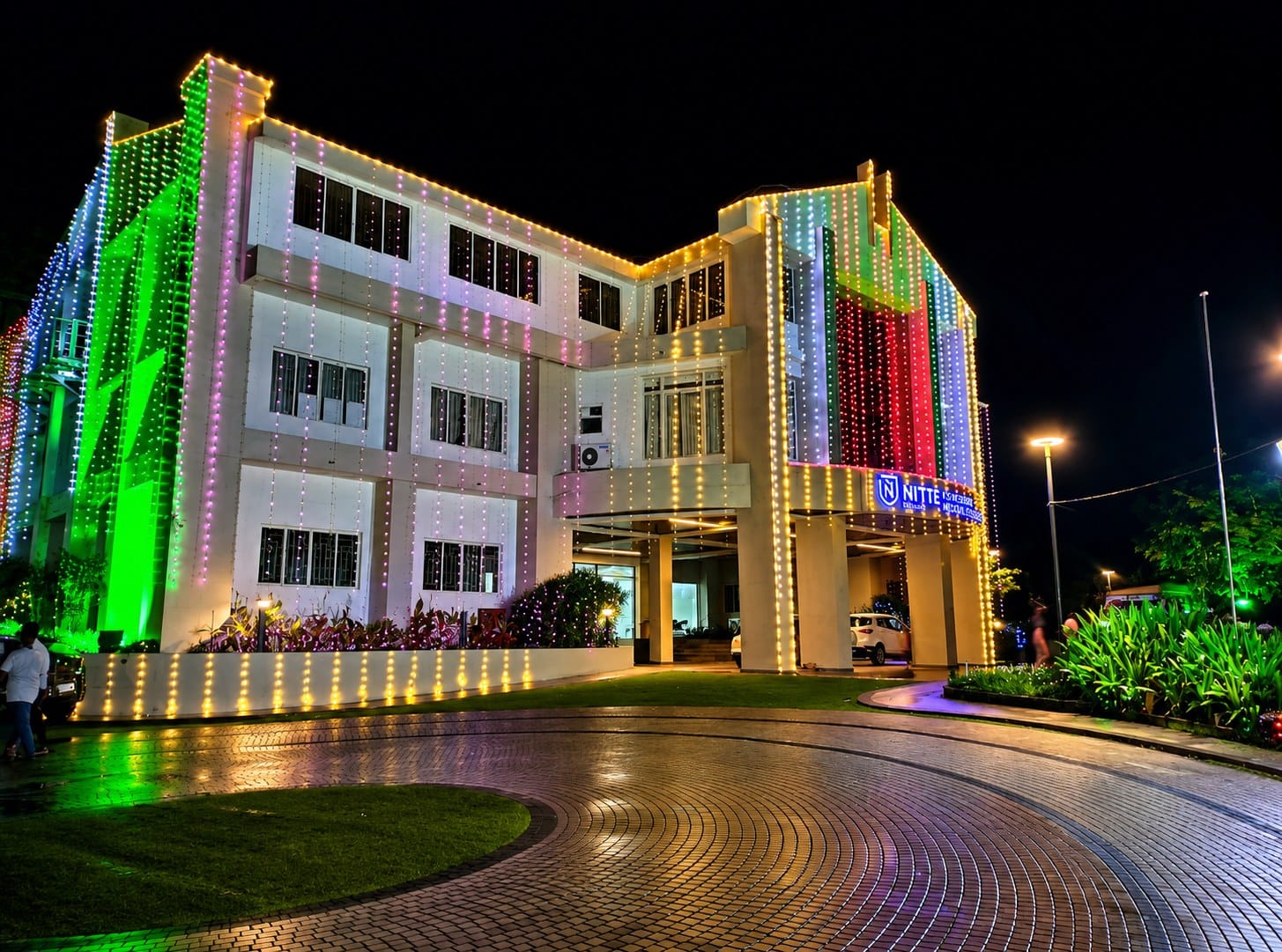A KS Hegde Medical Academy building illuminated at night, Mangalore