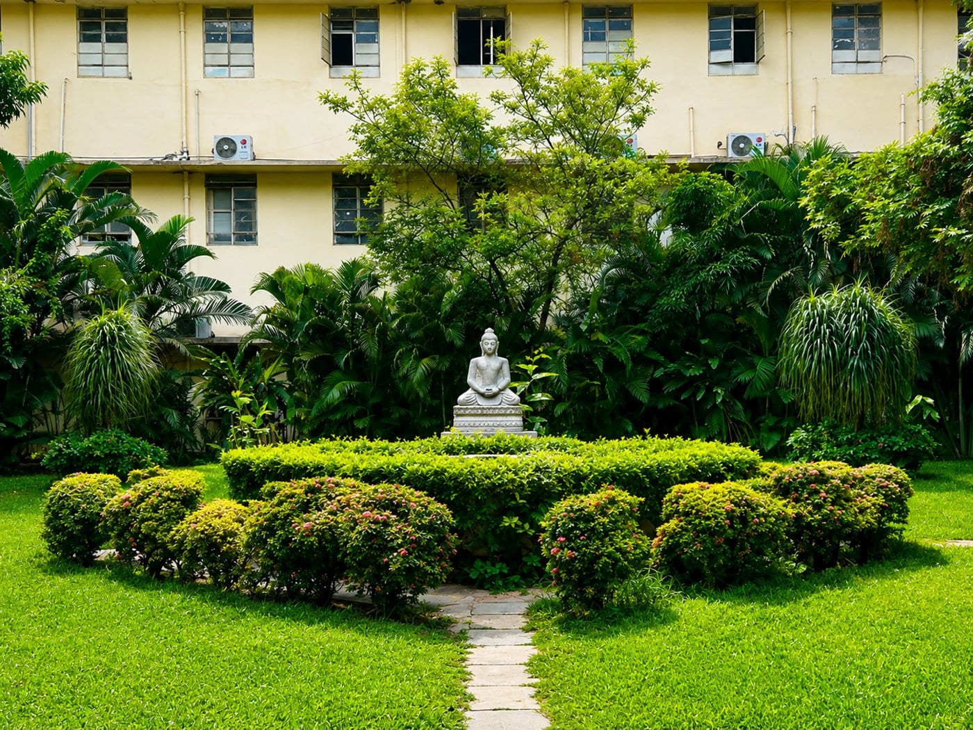 A garden with a statue on the Osmania campus