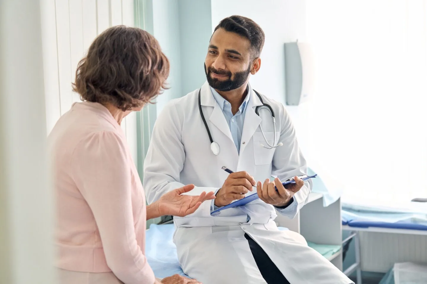 Indian,Male,Doctor,Consulting,Senior,Old,Patient,Filling,Form,At post graduate medical education medical courses - medical aspirants india mbbs fee world class education