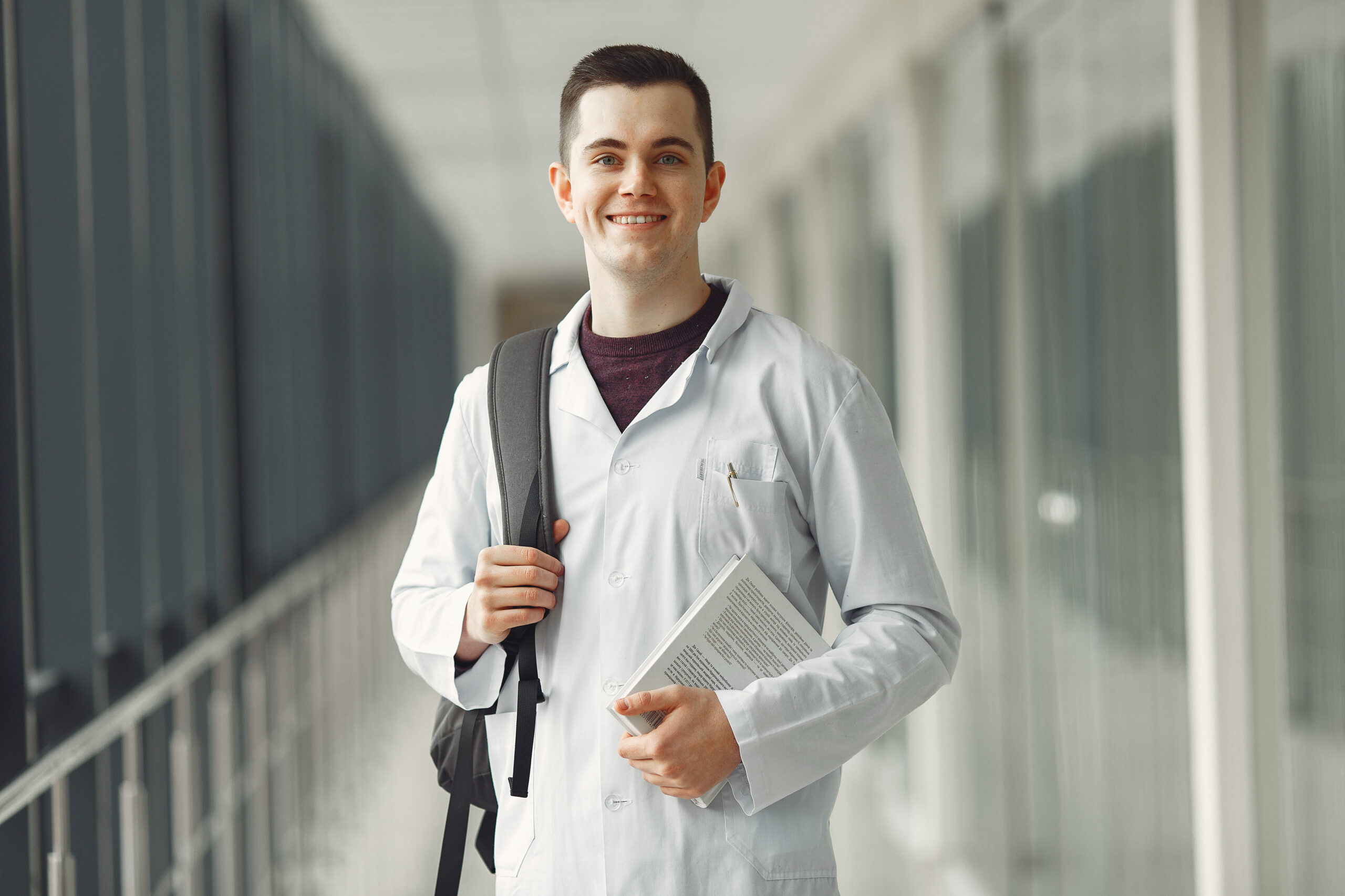 Medical student with backpack and books standing in foreign medical college