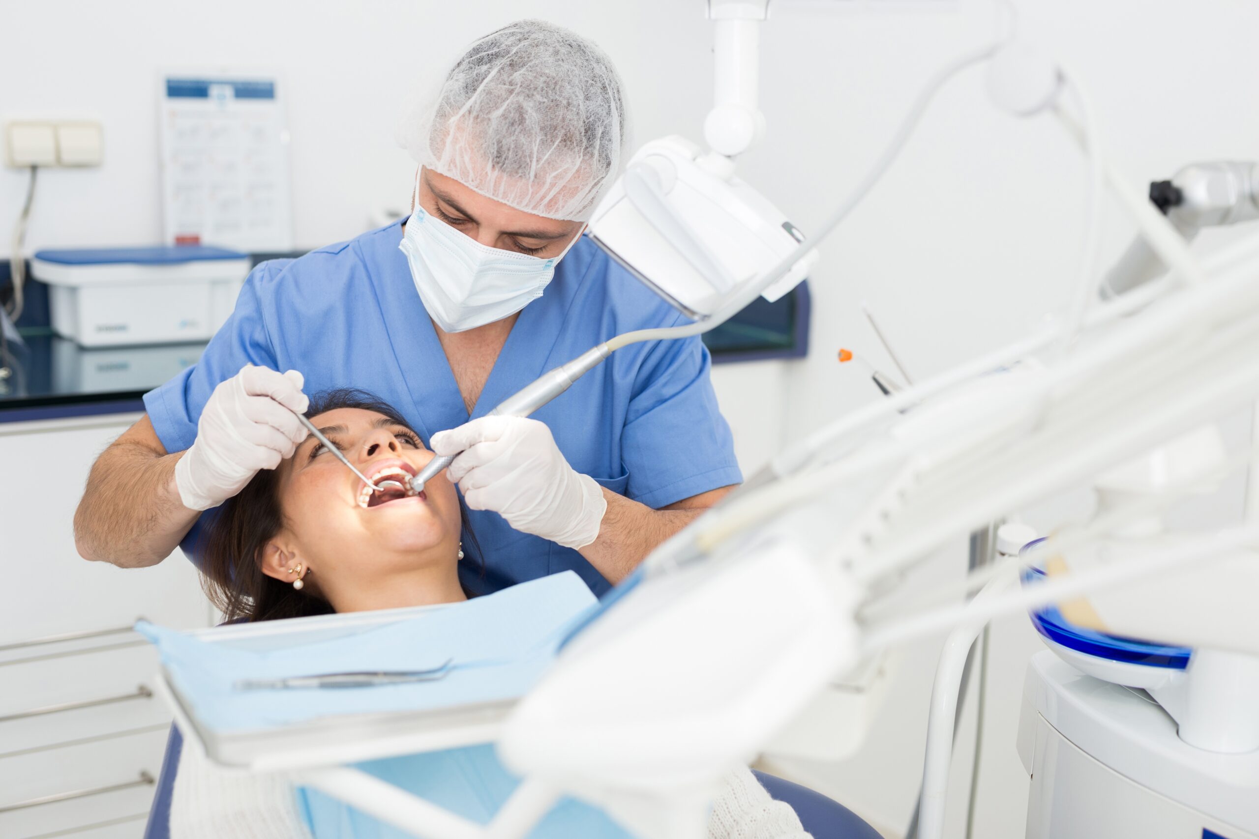 A dental surgeon diagnosing a patient